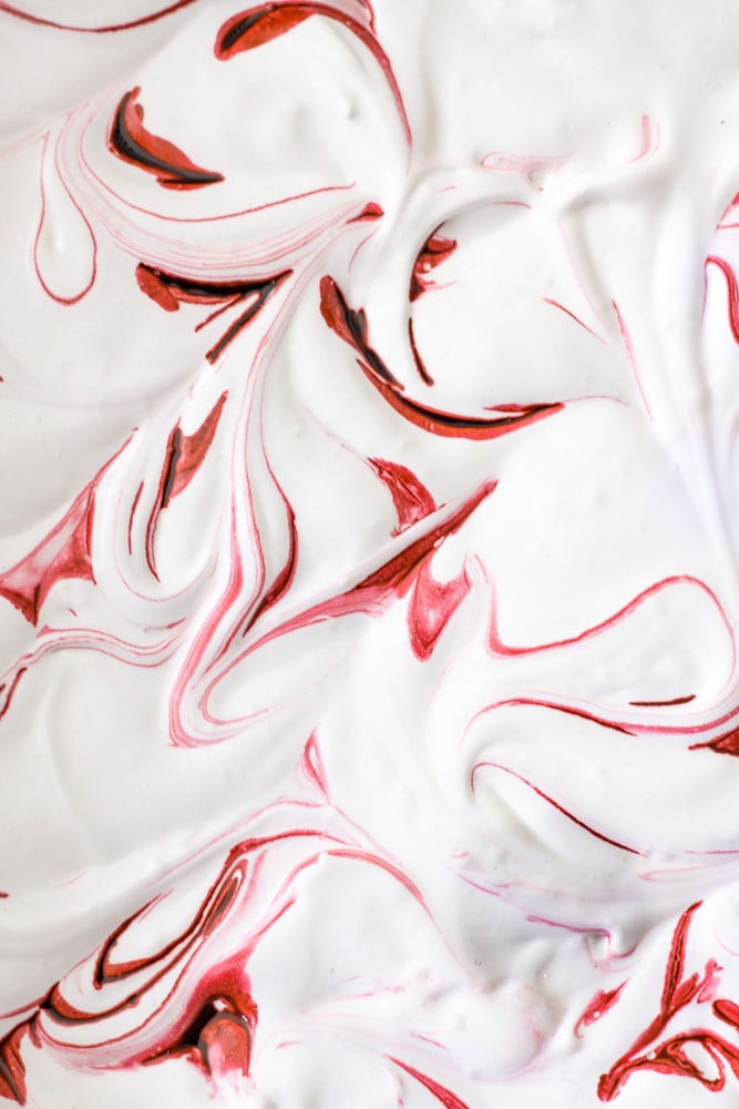 Close up overhead view of homemade peppermint marshmallows of red swirl.