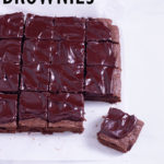 Slightly angled above view of fudgy, sliced red wine brownies with ganache.