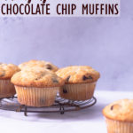 Straight on view of a cooling rack with Chocolate Chip Muffins on a white surface with a light blue background.