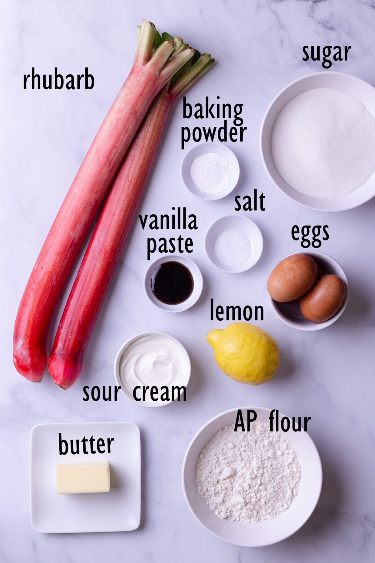 Ingredients including rhubarb, flour, sugar, eggs, baking powder, salt, lemon, butter, sour cream and vanilla.
