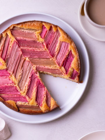 Overhead view of Rhubarb Cake with a slice cut out of it.