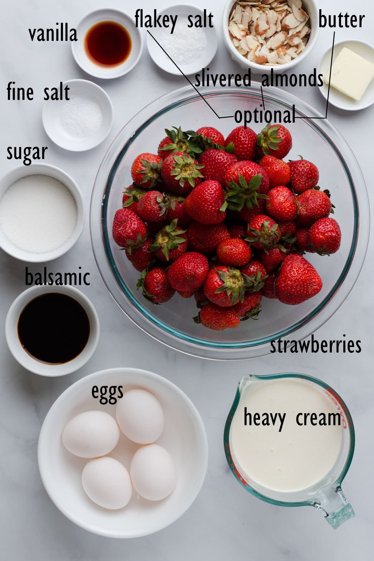 Ice cream ingredients, including strawberries, balsamic vinegar, eggs, cream and sugar.