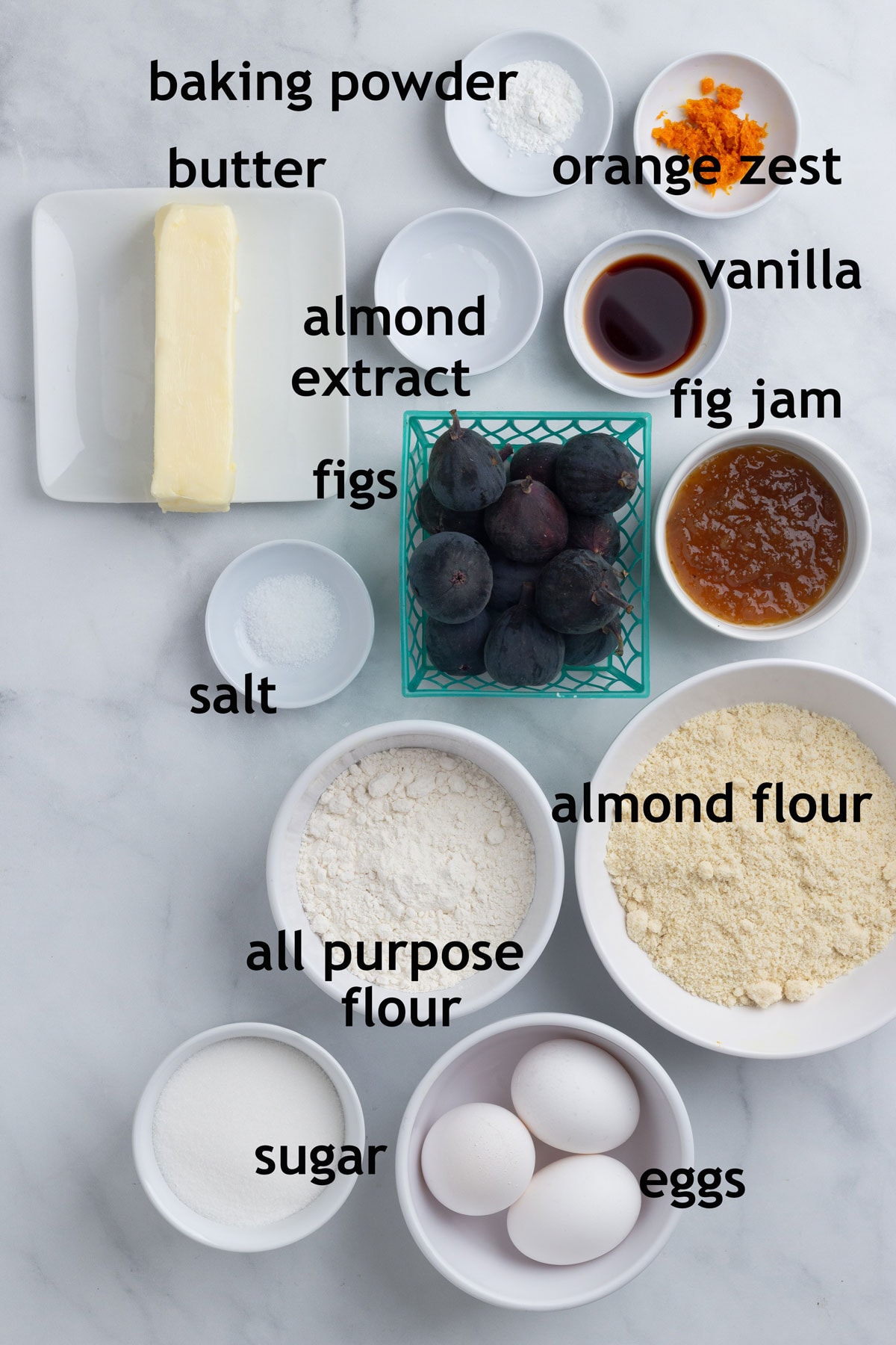 Ingredients with labels including butter, sugar, almond flour, figs, eggs and almond extract.