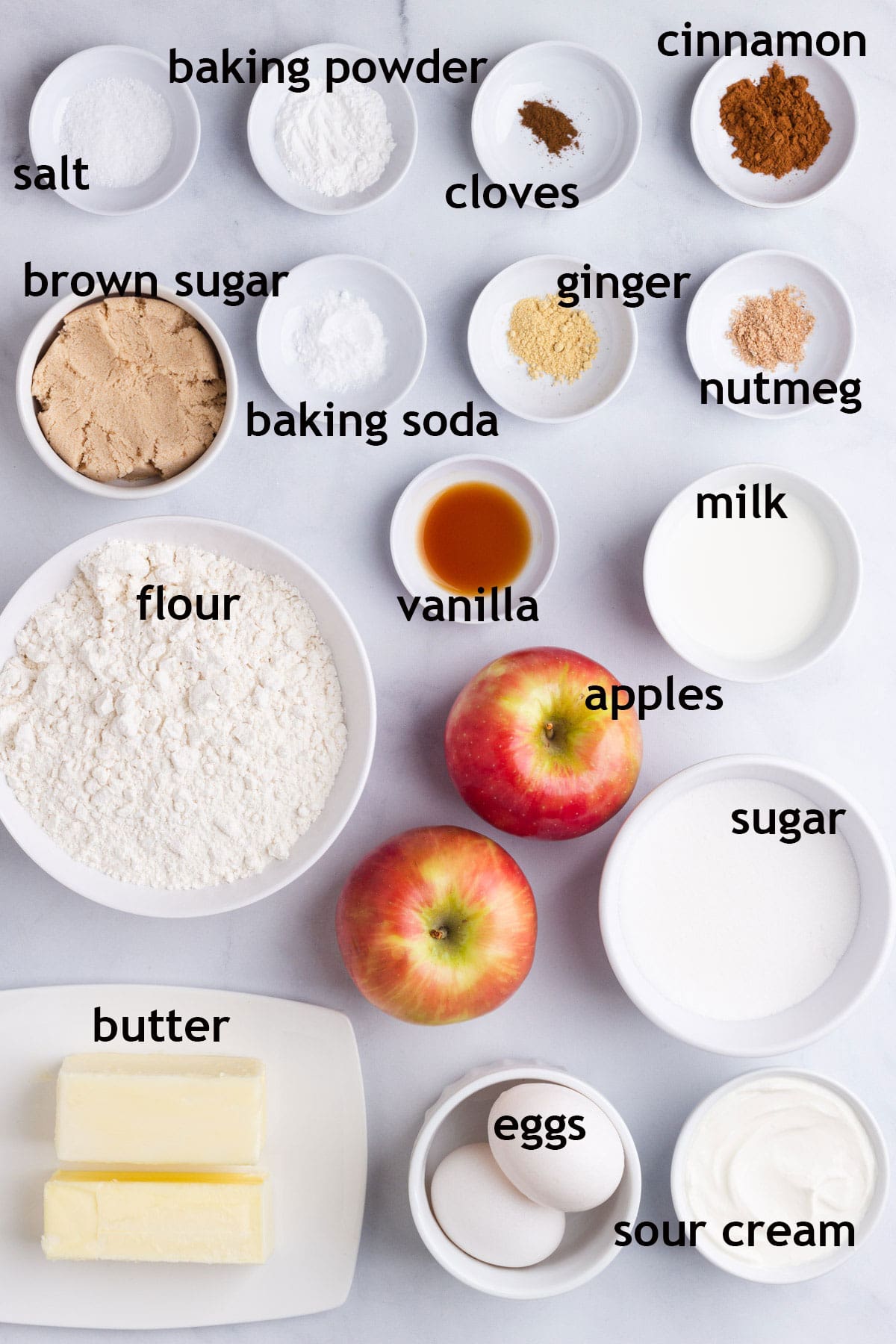 Muffin Ingredients including apples, flour, brown sugar, white sugar, butter, eggs, sour cream and spices.
