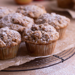 Close up view of Spiced Apple Sour Cream Muffins with Crumb Topping on a cooling rack.