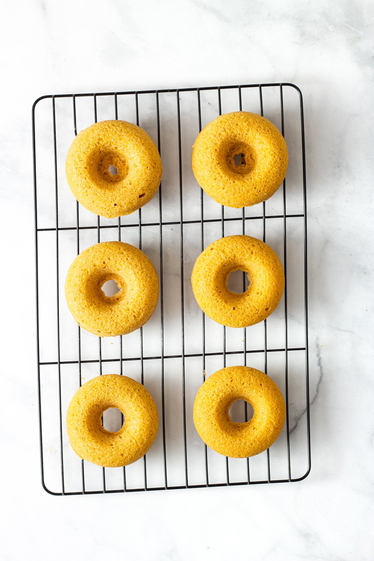 Pumpkin Donuts cooling on wire rack.