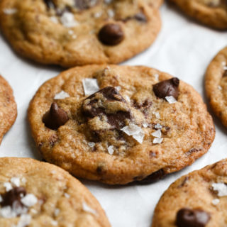Close up view, angled view of a cluster of salted, chocolate chip cookies.