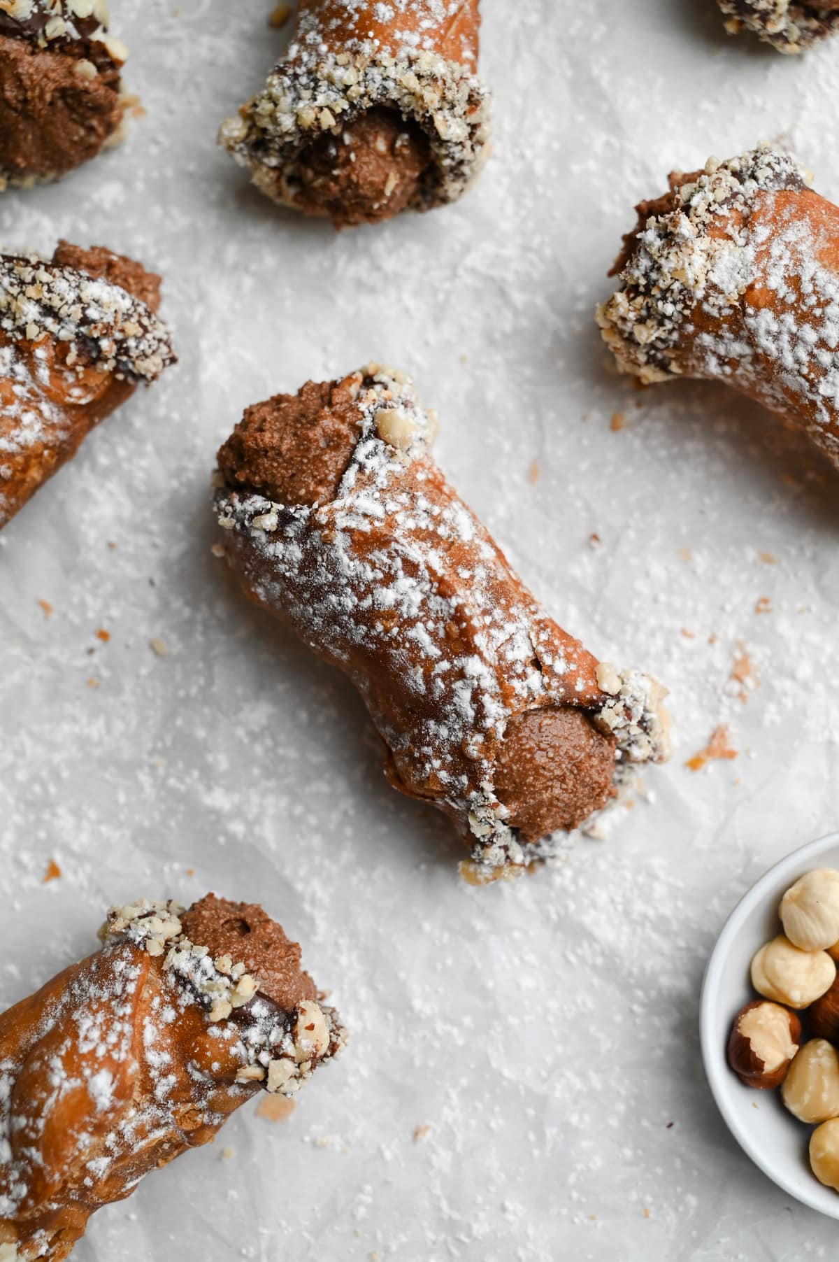Overhead view of a group of Chocolate Hazelnut Cannoli on parchment paper.