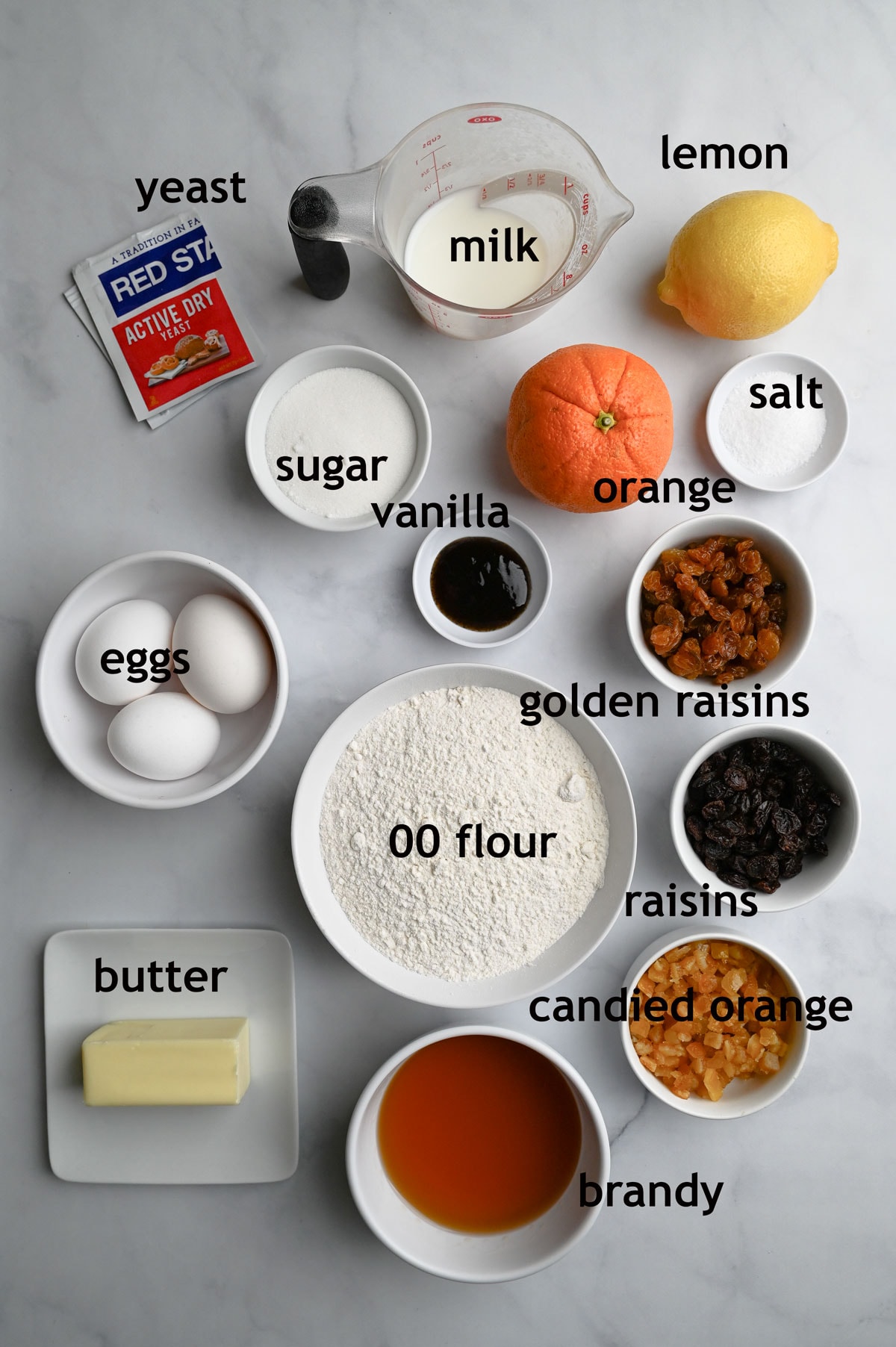 Ingredients for Panettone, including 00 flour, eggs, butter, milk, sugar, yeast and dried fruits.