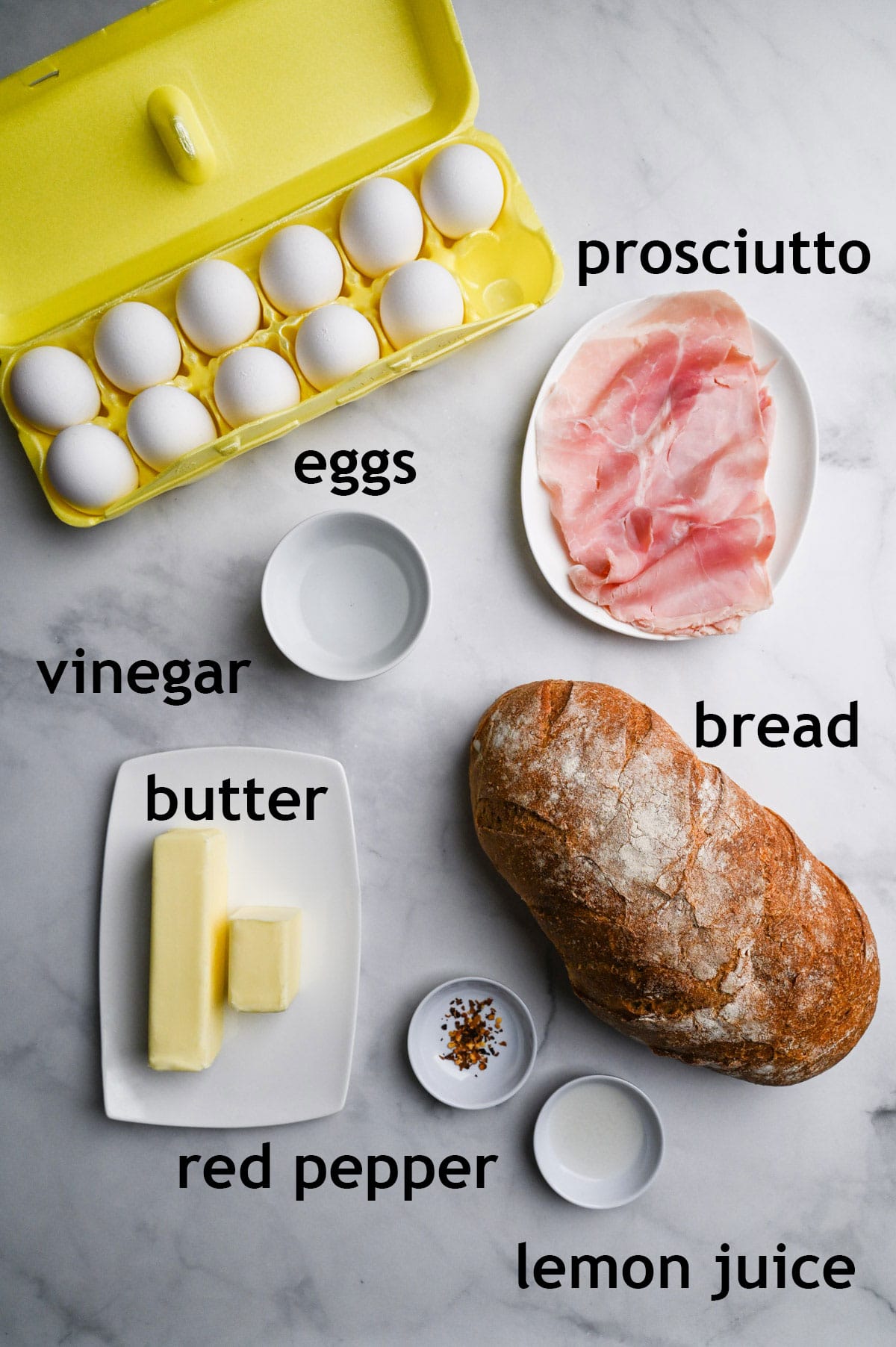 Ingredients including eggs, prosciutto ham, bread, butter, red pepper, lemon juice and white vinegar.