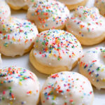 Close up view of a plate of Italian Knot Cookies topped with glaze and colored sprinkles.