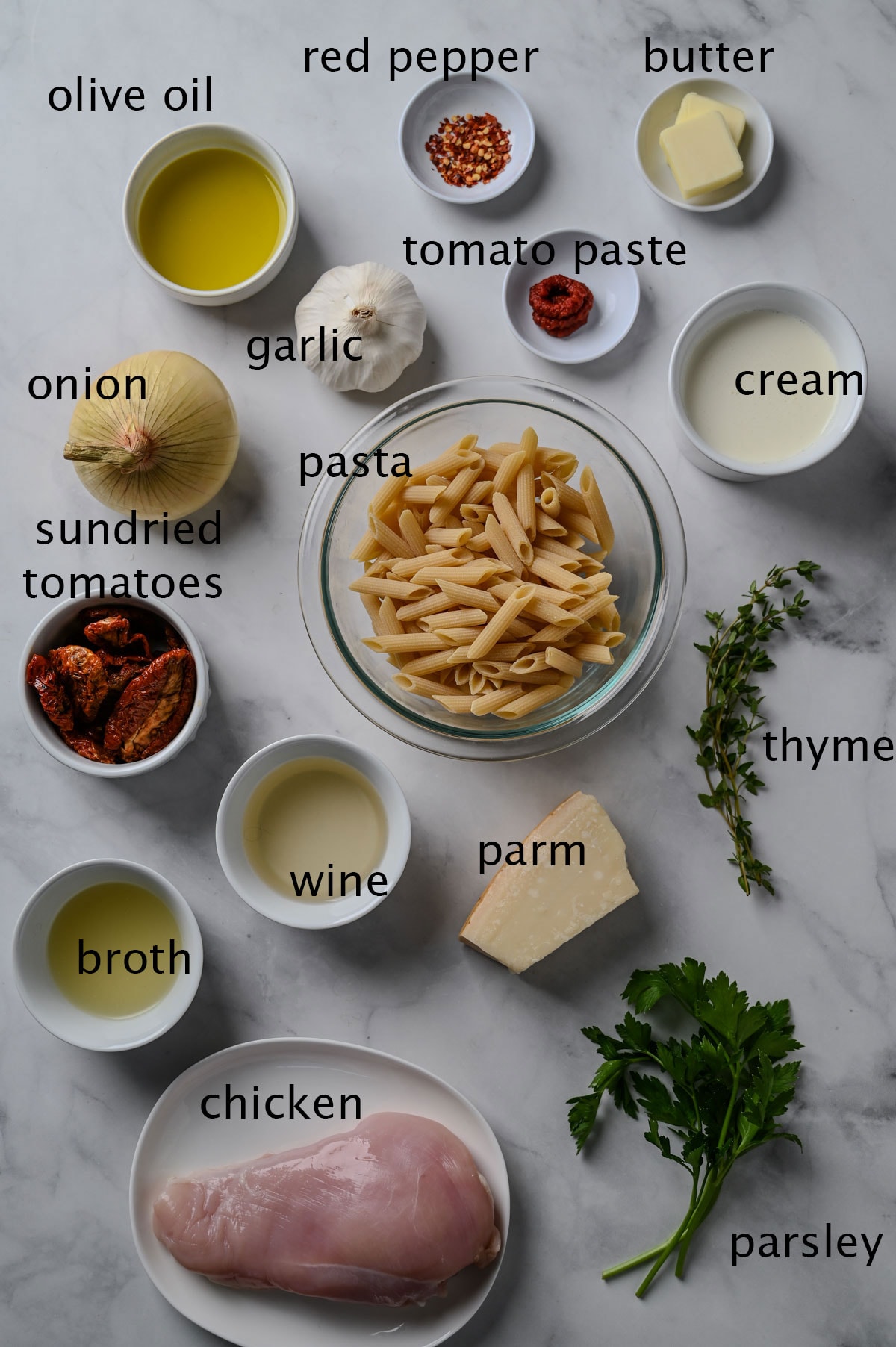 Labeled ingredients for pasta with chicken, cream, tomato paste, sundried tomatoes and herbs.